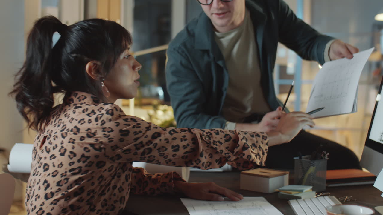 Colleagues Working on Architectural Project Late in Office