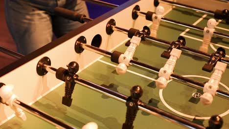 players engaged in a foosball match