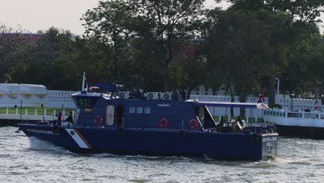 military vessel cruising along a calm river