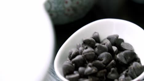 nice close up shot of semi-sweet chocolate chips with red beet pulp in the foreground