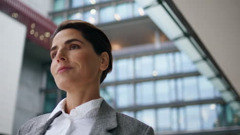 Happy-executive-walking-downtown-closeup.-Smiling-beautiful-employee-posing