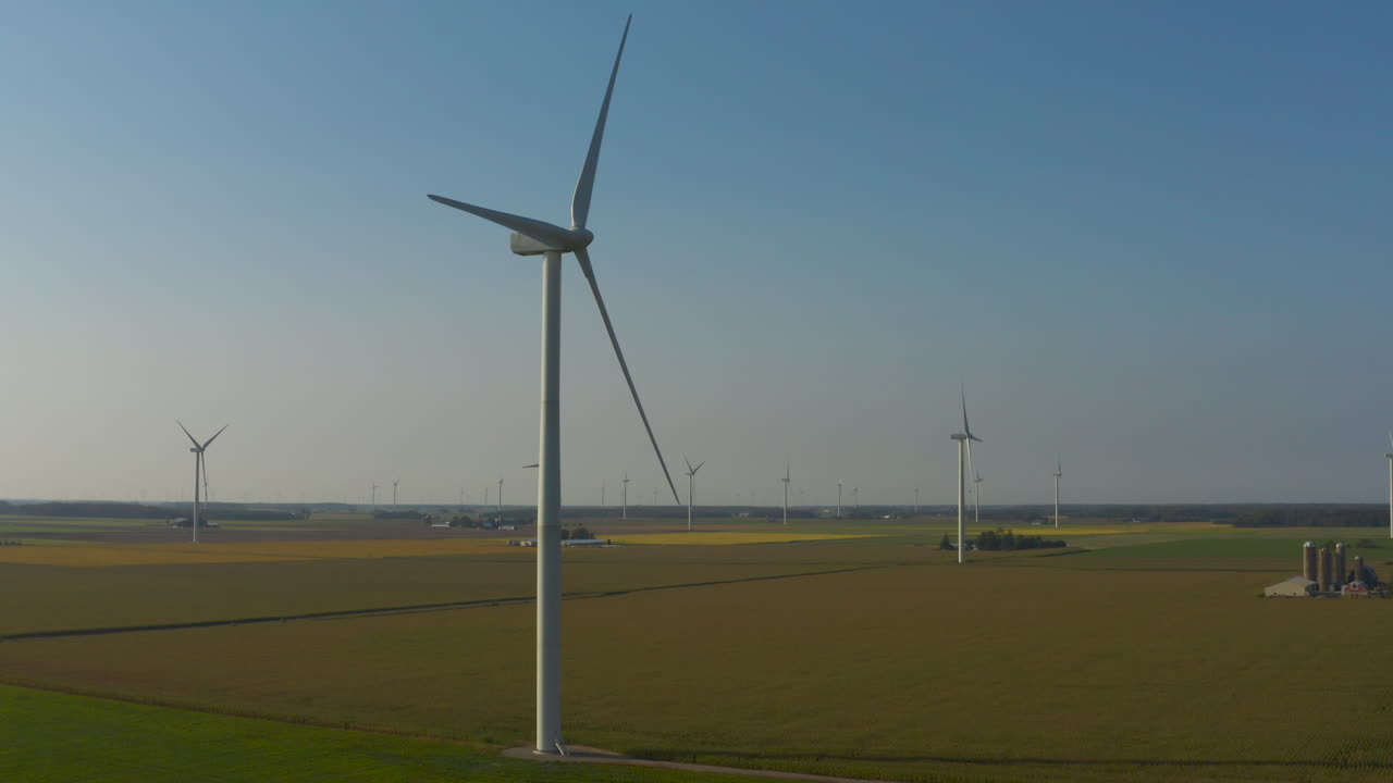Wind Turbine spins over farm land