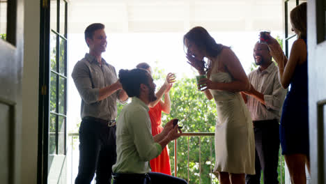 man proposing woman with ring by kneeling down