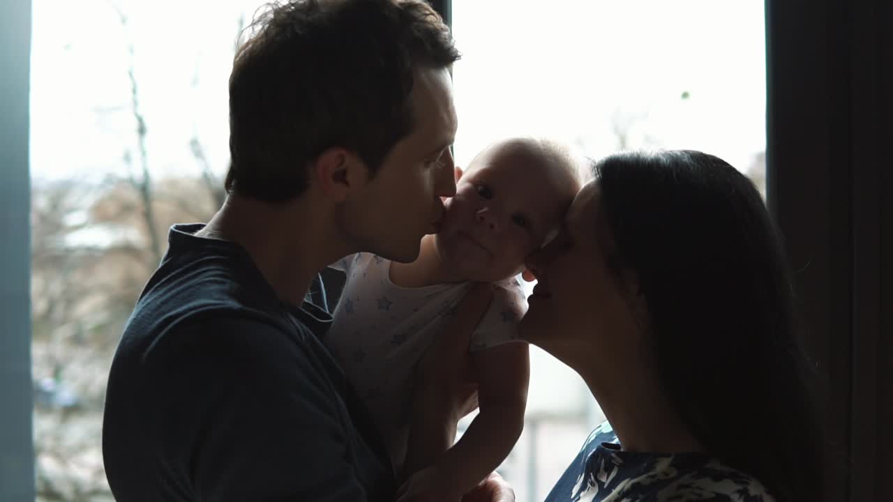 A loving family moment with parents and baby