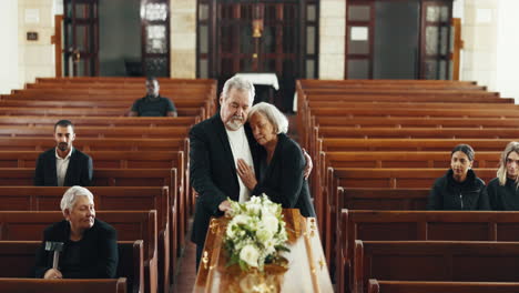 funeral, church and couple hug by coffin