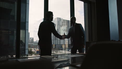 businessmen shaking hands in an office