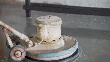 Slow-motion-shot-of-man-polishing-floors,-close-up-shot