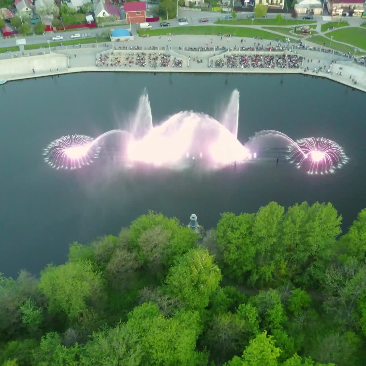 Beautiful Dancing Fountain. Aerial shot of the colorful illuminated musical fountain at dusk
