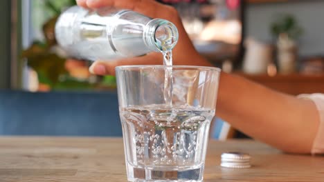 pouring soda water into a glass