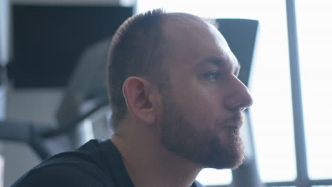 extreme close up pan right of a man looking pensive