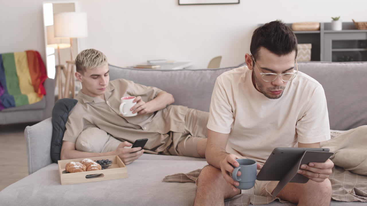 Couple Sitting Sofa at Home and Having Bite