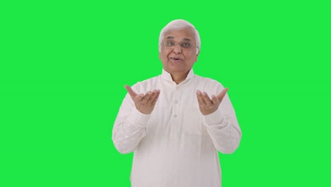 Happy-Indian-old-man-talking-to-someone-Green-screen