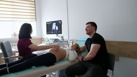 pregnant couple at ultrasound appointment
