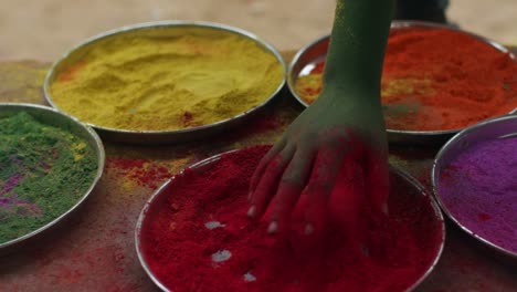 indian women close-up of face smeared with bright holi colors