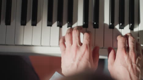 primer plano íntimo de las manos hábilmente tocando el piano, mostrando la interacción precisa con las teclas blancas y negras contra un fondo borroso. este video captura la esencia de la expresión musical