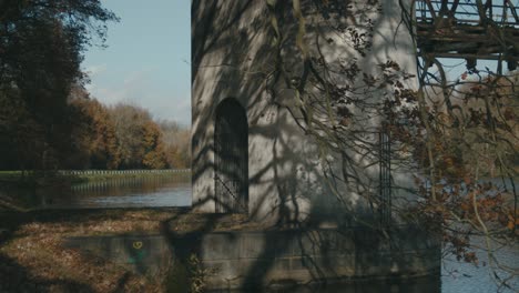 Concrete-Structure-Of-Stary-Labsky-Jez-Obristvi-With-Autumn-Tree-Shadows-On-Wall-Beside-River-Elbe