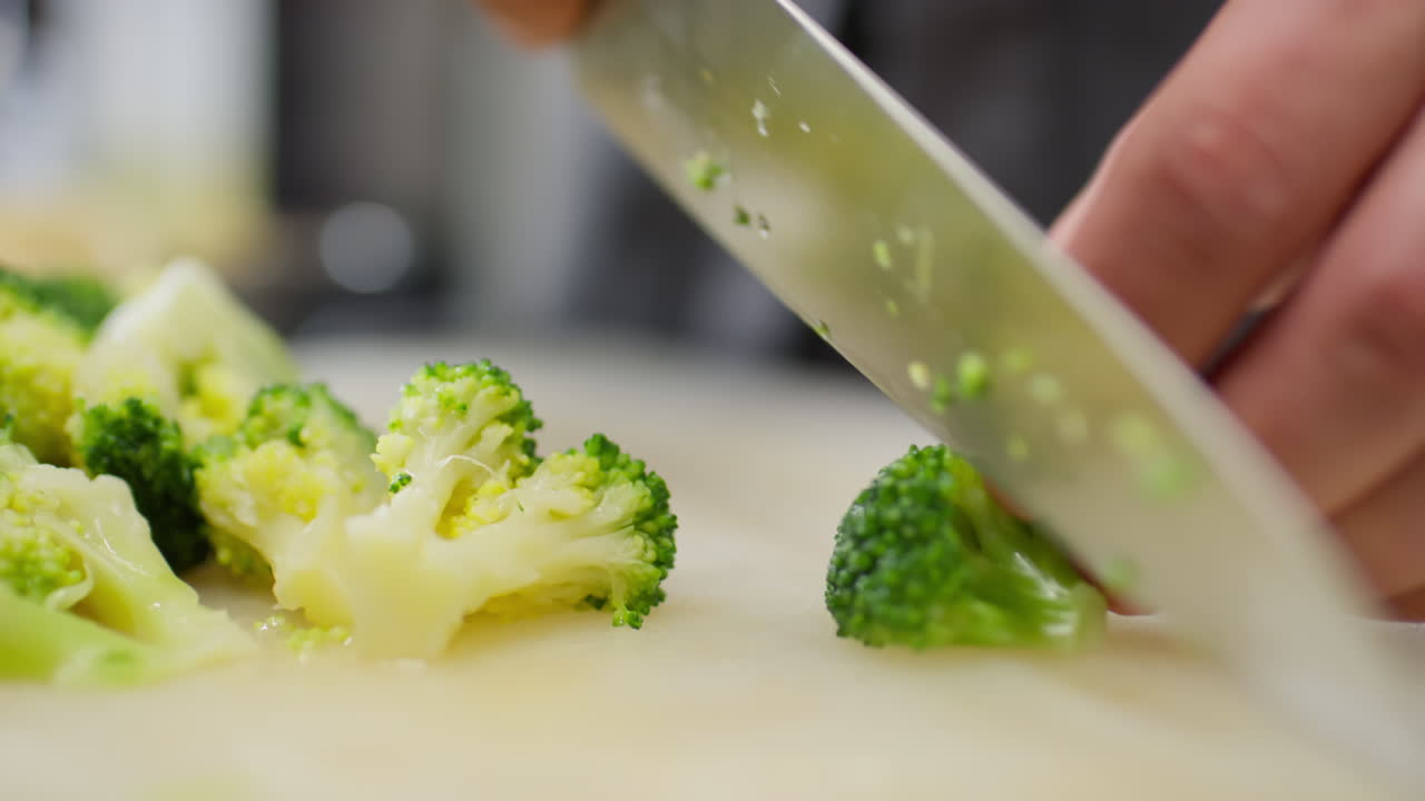 Male Hands Cutting Broccoli