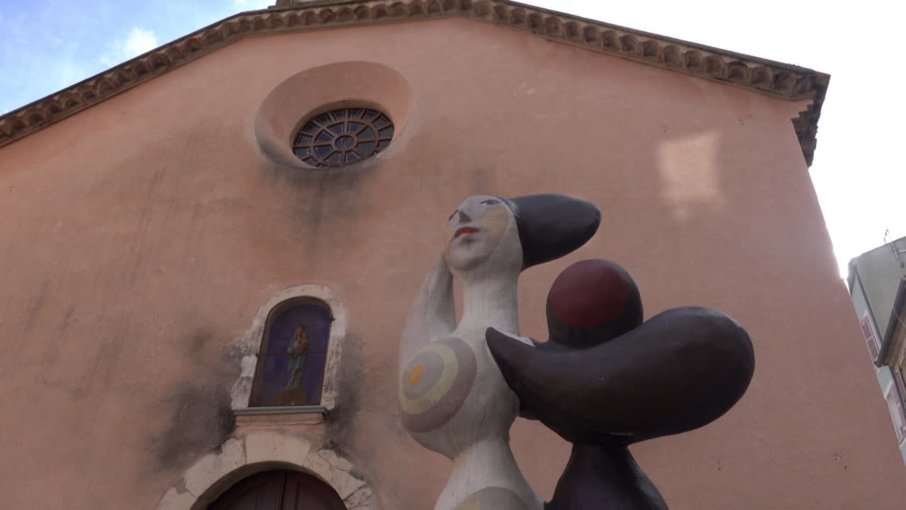 Vallauris, France - March 19, 2025: Street sculpture by Roger Capron near a church in daylight