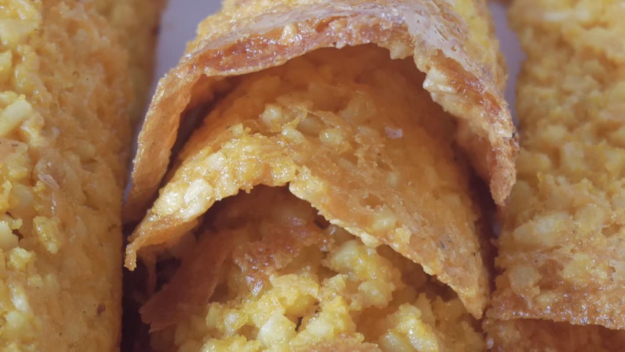 Slow pan of almond-based tejas with vibrant golden color and crispy surface