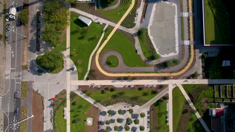 Aerial-view-of-a-symmetrically-designed-park-with-pathways,-greenery,-and-adjacent-roads-in-center-of-Gdynia,-Poland