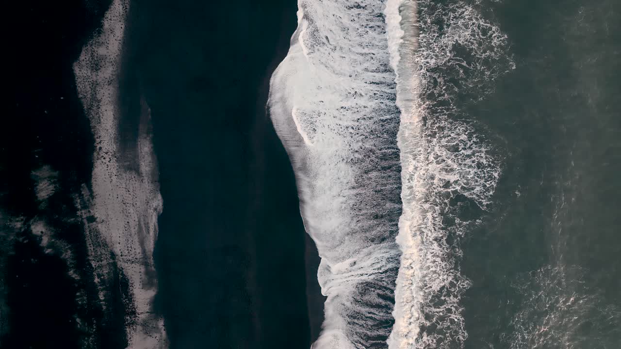 Top View Of Waves Splashing On Black Sand Beach In Vik, South Iceland - Drone Shot
