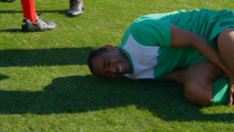 injured football player being assisted by other players 4k