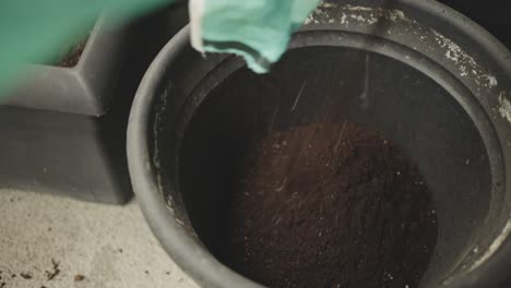 pouring planting soil into plant pot. closeup