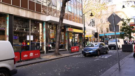 vehicles and pedestrians on a bustling melbourne street