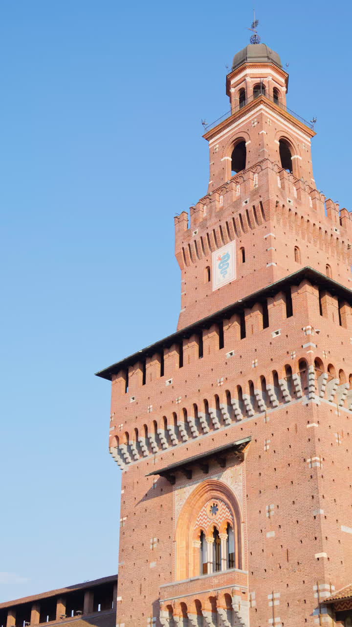 View of the Filarete Tower in Milan, Italy on the blue sky background. Vertical