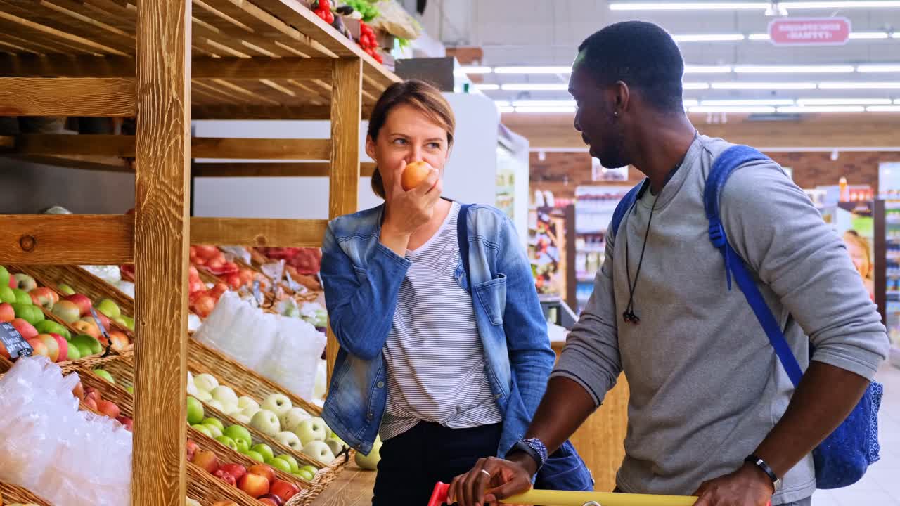 A Pair of Friends Exploring Fresh Produce in a Vibrant Market: Choosing the Best Fruits and Vegetables for a Healthy Lifestyle Together