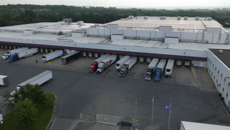 aerial view of semi-trucks parked at different stations at warehouse loading bay