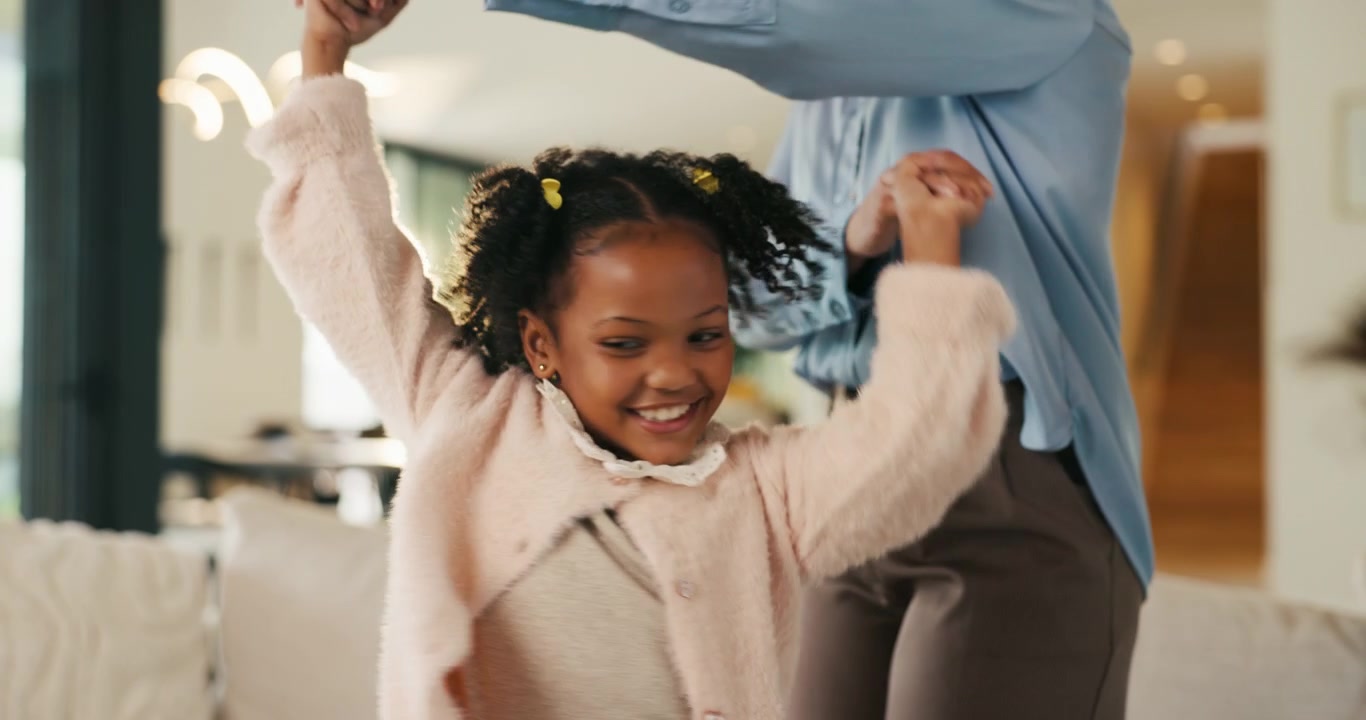 Young Girl Dancing and Spinning with Her Mother at Home