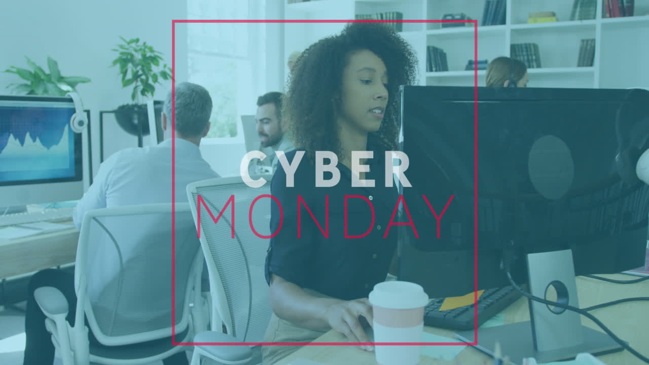 Animation of cyber monday text banner against african american woman using computer at office