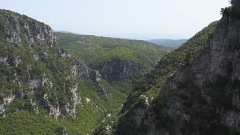 An-aerial-passing-into-the-largest-canyon-in-Greece,-Vikos-gorge