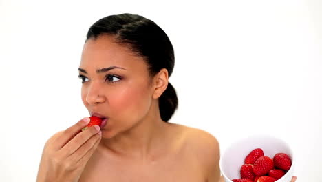 Happy-gorgeous-woman-holding-a-bowl-with-strawberries