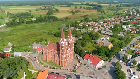 iconic church building and countryside landscape with small town, aerial drone view