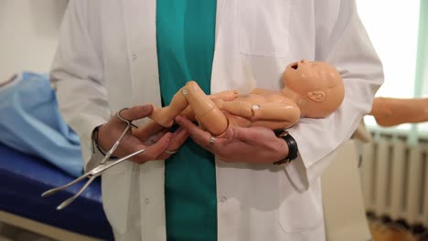a skilled medical professional showcases childbirth techniques through the use of a baby dummy during training.