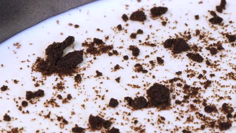 Macro-shot-of-homemade-chocolate-and-cream-cheese-cake-into-a-metal-pot,-rotating