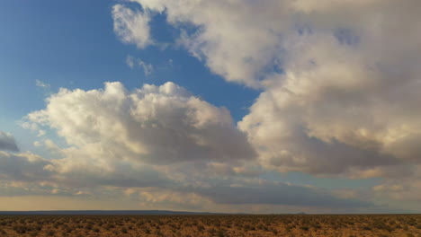 rain clouds over the mojave desert landscape promise necessary rain - sliding aerial view