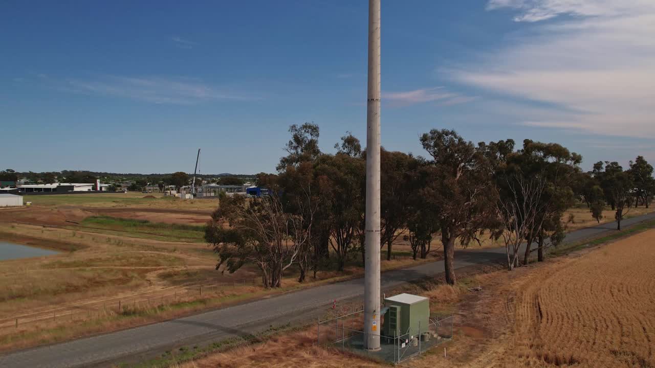 Aerial rising up a mobile phone tower with the town of Yarrawonga in the background
