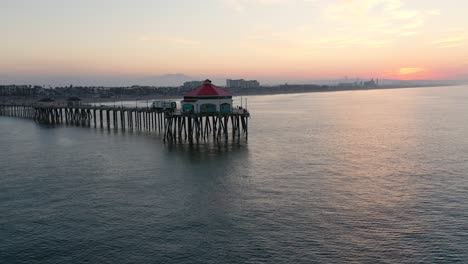 A-stunning-4k-View-of-the-pier-in-Surf-City-USA-at-sunrise-as-tourists-and-people-on-vacation-enjoy-the-view