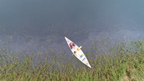 man rowing a boat on a lake 4k