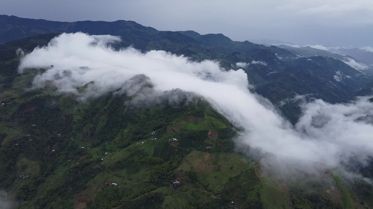 Dramatic Cloud Formation Flowing Over Green Mountains