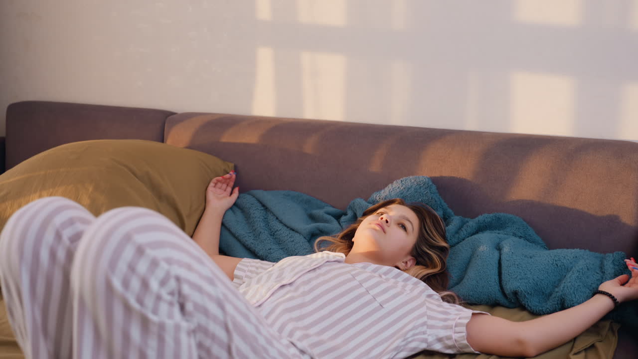 Calm Woman Resting, Young Lady Relaxing Peacefully At Home, Serene Woman In Pajamas Enjoying Tranquil Indoor Moments, Relaxed Female Resting Comfortably While Lounging At Her Cozy Residence