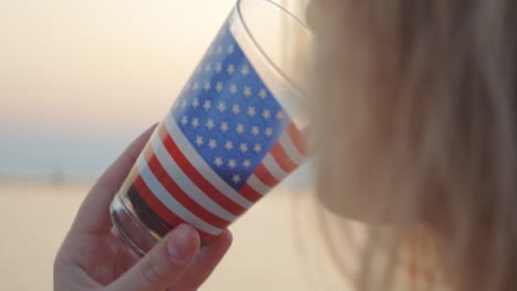 Woman-pouring-and-drinking-liquid-in-glass-cup