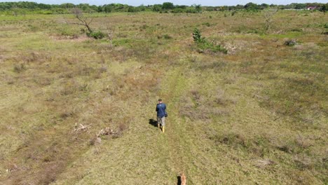 Man-on-the-plain,-accompanied-by-dog