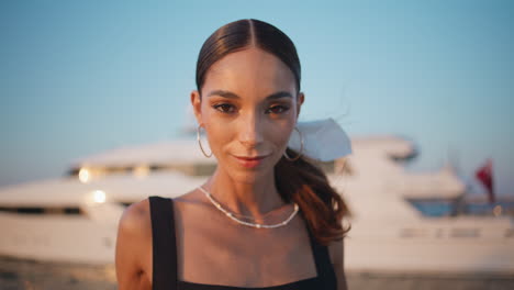 woman by a yacht at sunset