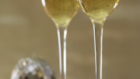 champagne glasses on green background at new year's eve