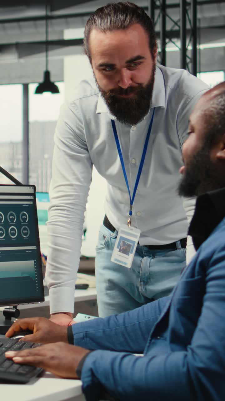 Vertical Video Diverse corporate team focuses on data management on computer