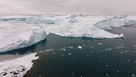 drone over sea and ice of ilulissat icefjord